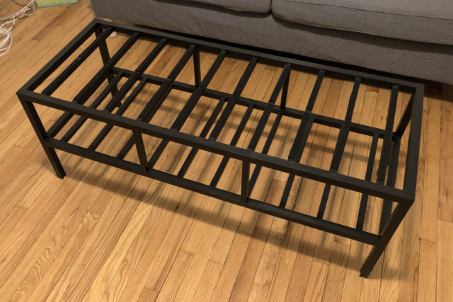 Slatted frame of wooden coffee table painted black
