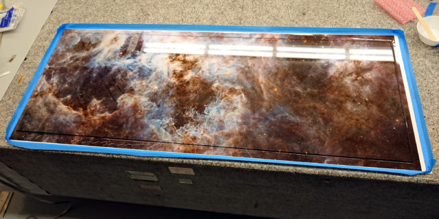 Photo print with glass epoxied to the top of it, sitting on a granite table